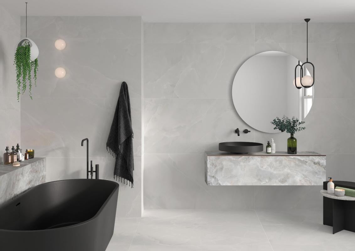 Modern bathroom with black freestanding bathtub and Spanish white porcelain tile on the walls and floor
