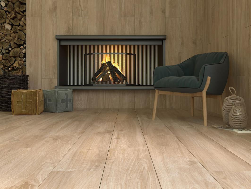 Cozy living room with honey-oak wood-look plank floors and matching wood walls, fireplace, and teal armchair