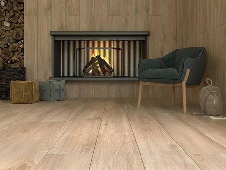 Cozy living room with honey-oak wood-look plank floors and matching wood walls, fireplace, and teal armchair