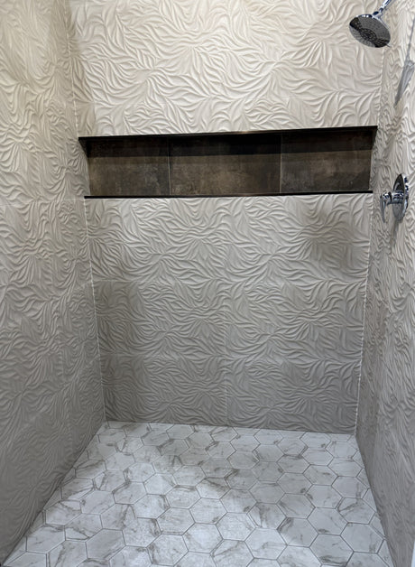 Finished tiled walk-in shower — waterproofing and backer behind the tile are what keep the structure dry