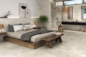 Modern bedroom with wooden platform bed and bench with Spanish porcelain cream tile floor and walls.