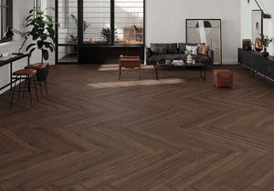 Modern living room with chevron wood-look porcelain tile flooring, furniture, and decor.
