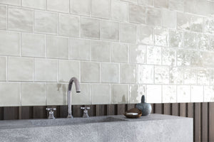 Bathroom with tiled wall, sink, and decorative elements